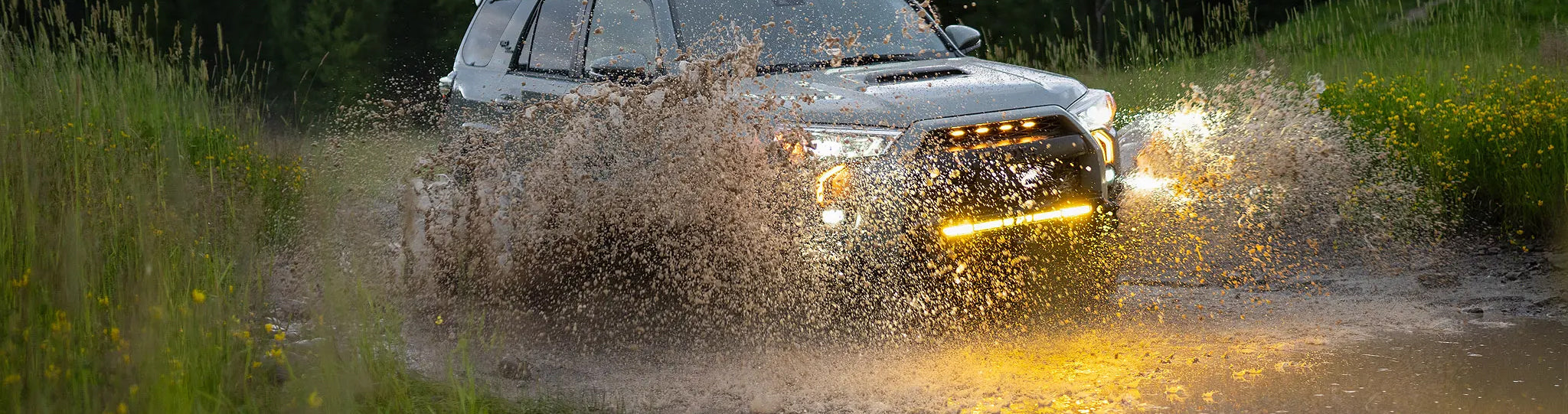 overland sector wheels toyota 4runner driving through pond water in montana