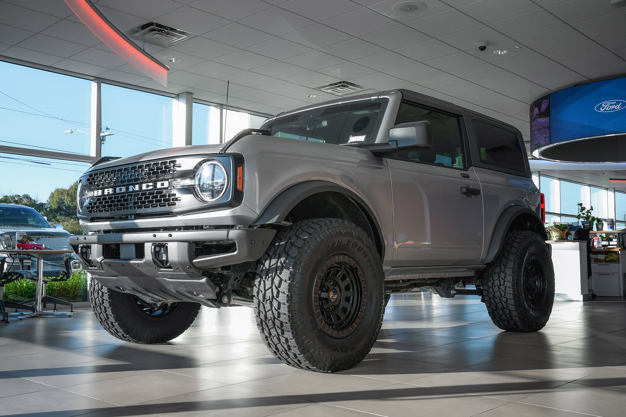 overland sector wheels ford bronco 2 door on 17x9 satin black venture wheels on showroom floor at ford dealership up close