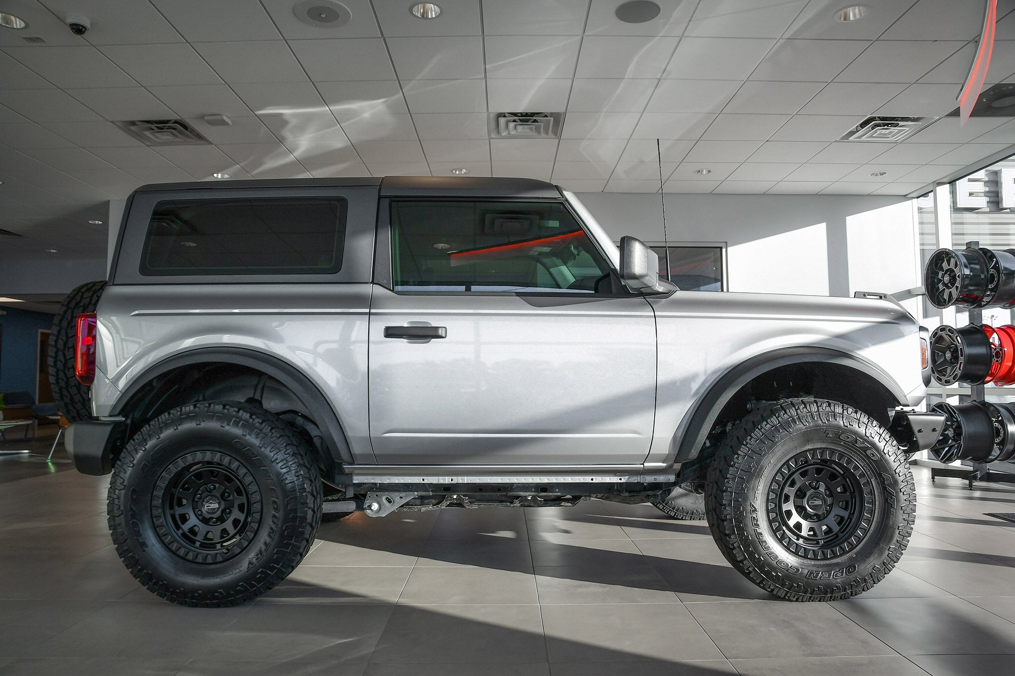 overland sector wheels ford bronco 2 door on 17x9 satin black venture wheels on showroom floor at ford dealership up close