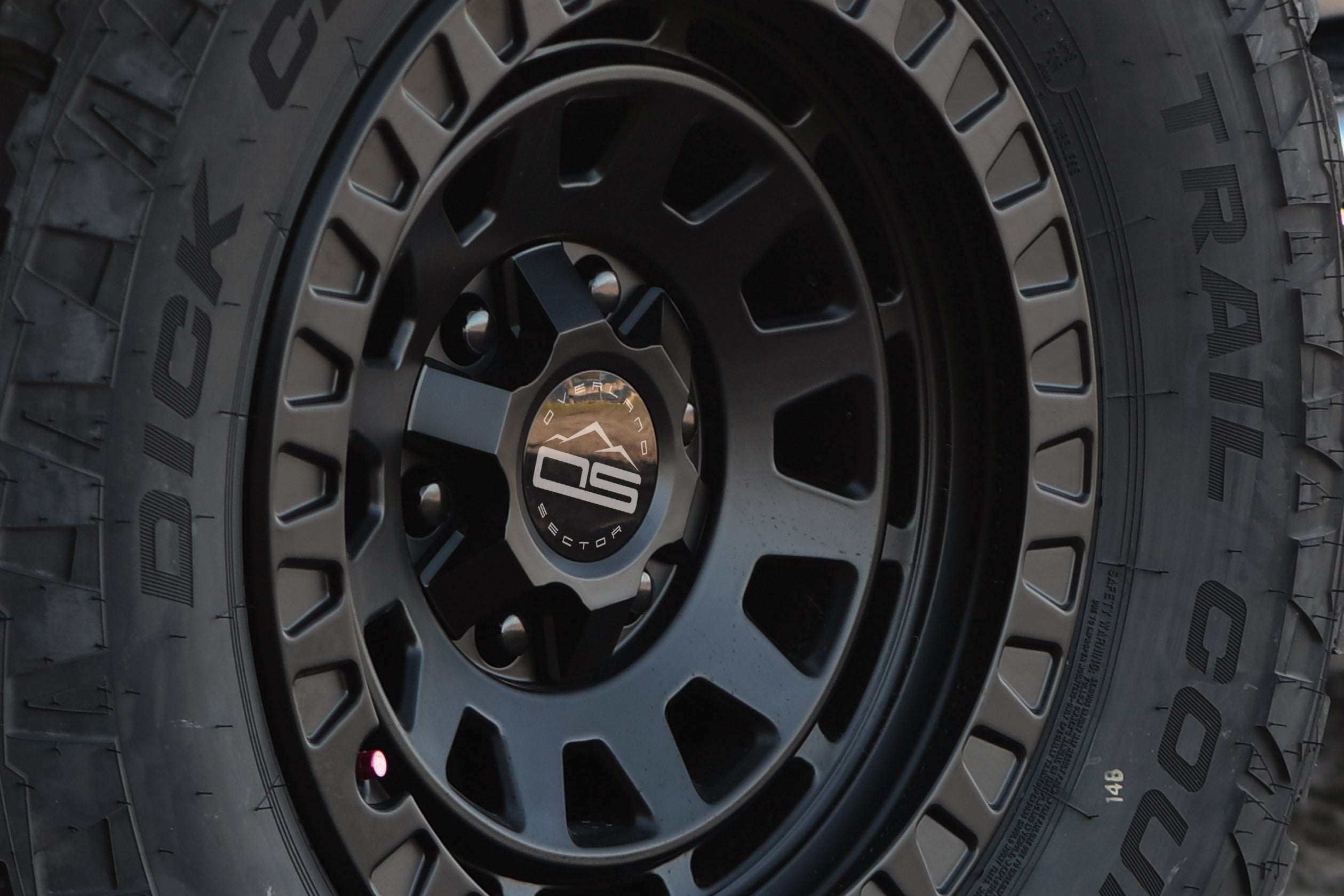 overland sector wheels center cap up close wheel on tires venture atlas wheels hardware collection off-road