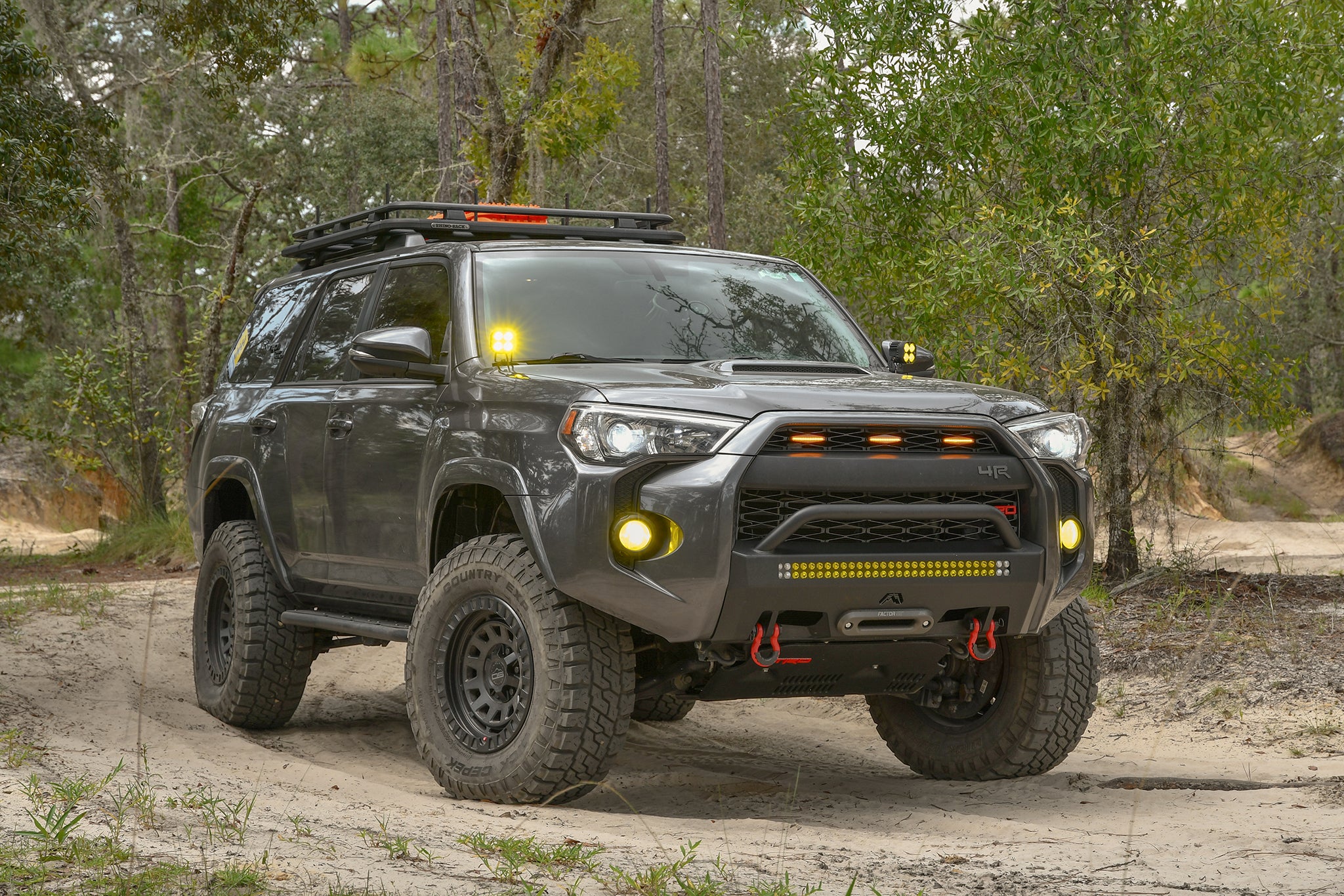 overland sector wheels toyota 4runner trd off-road on 17x9 satin black venture wheels on dirt trail in woods