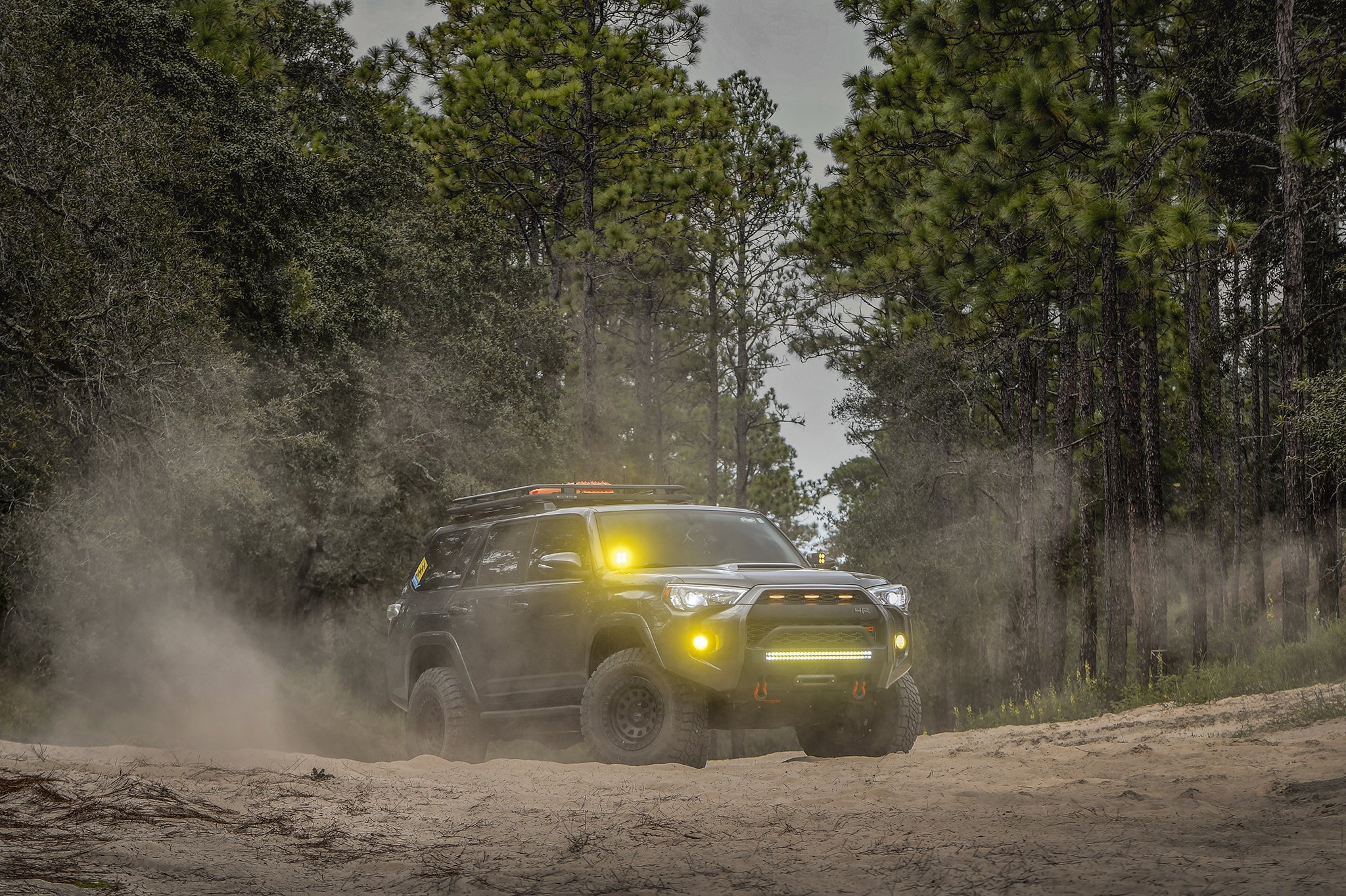 overland sector wheels toyota 4runner trd off-road on 17x9 satin black venture wheels on dirt trail in woods