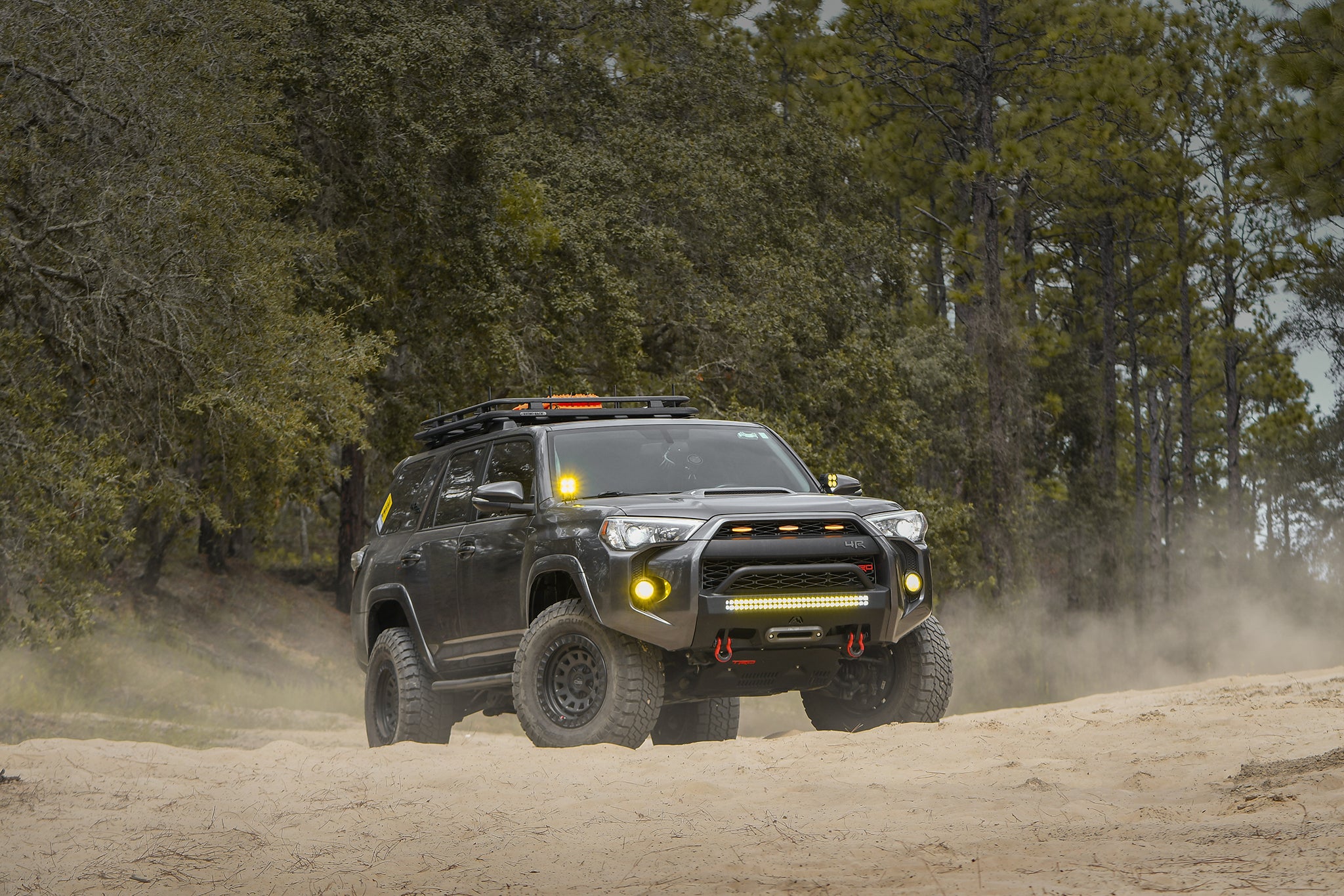 overland sector wheels toyota 4runner trd off-road on 17x9 satin black venture wheels on dirt trail in woods