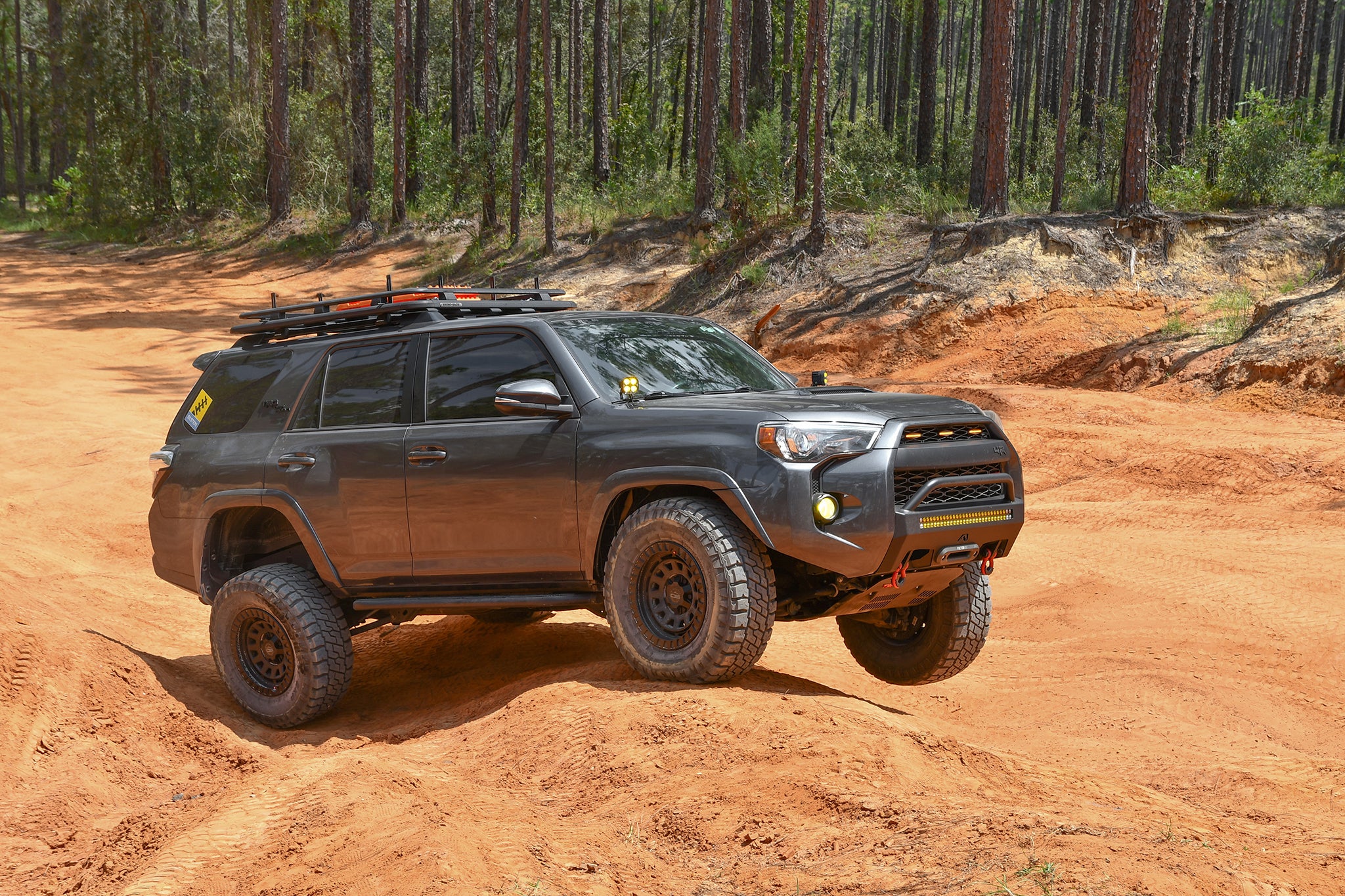 overland sector wheels toyota 4runner trd off-road on 17x9 satin black venture wheels on red dirt clay trail in woods
