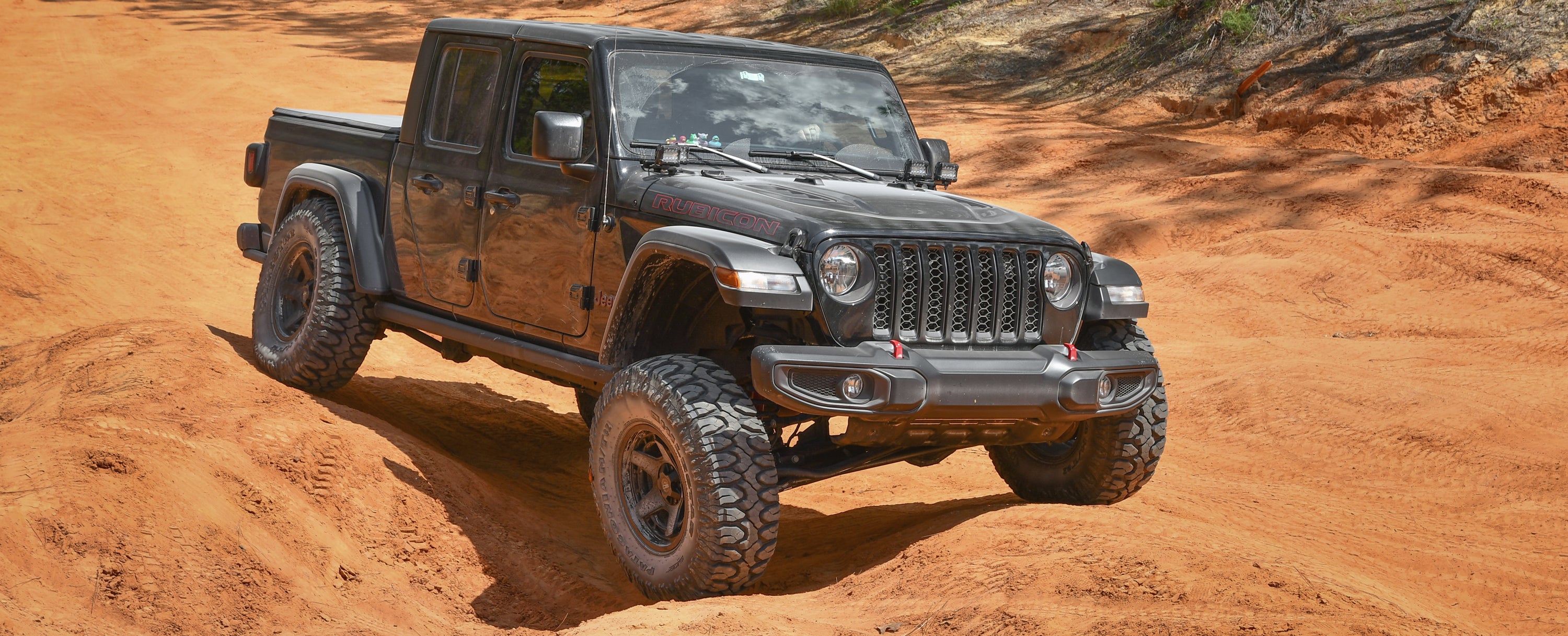 overland sector jeep gladiator rubicon on satin black venture on clay trail